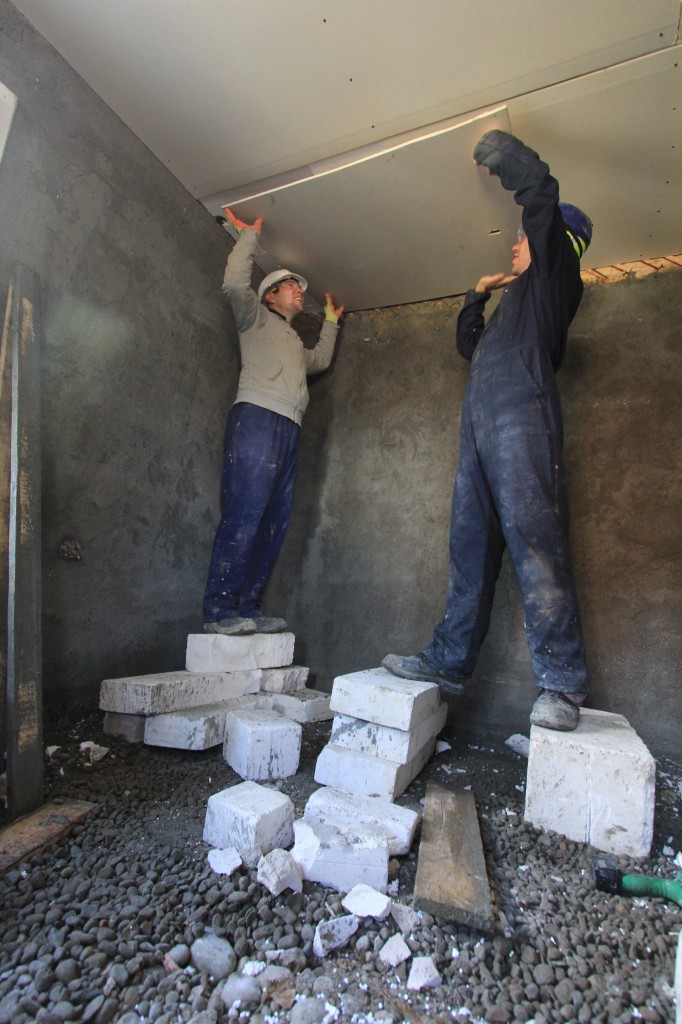 AJ and I attaching the last piece of plasterboard