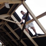 Sam working on the roof of the larger house
