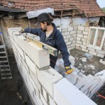 Sam laying the last layer of blocks