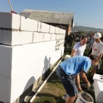 Simon and Silviu applying polystyrene insulation