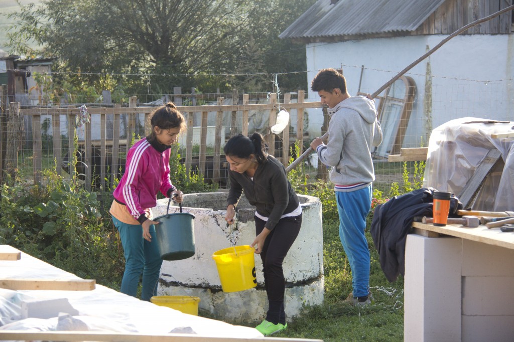 The family help us by drawing water from the well