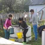The family help us by drawing water from the well