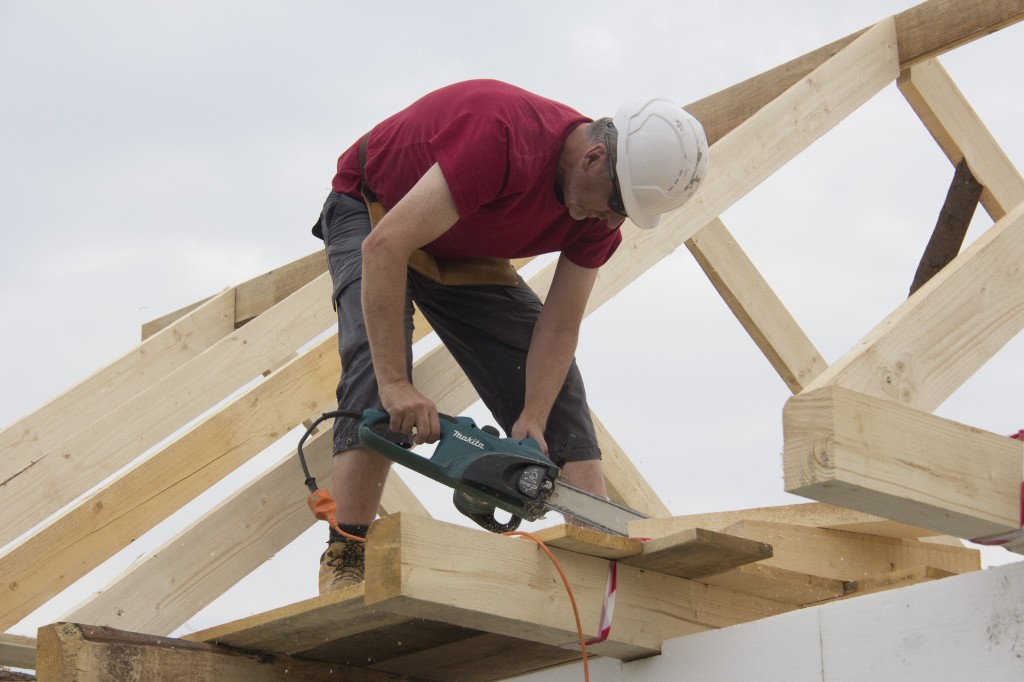 Martin working on the roof of the larger house